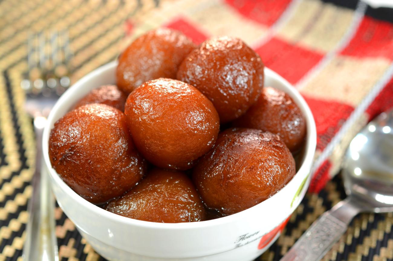Gulab Jamun is an Indian dessert made out of condensed milk balls and sugar. They are fried and soaked in sugar syrup. It is a popular Indian sweet dish prepared during Indian festival Diwali