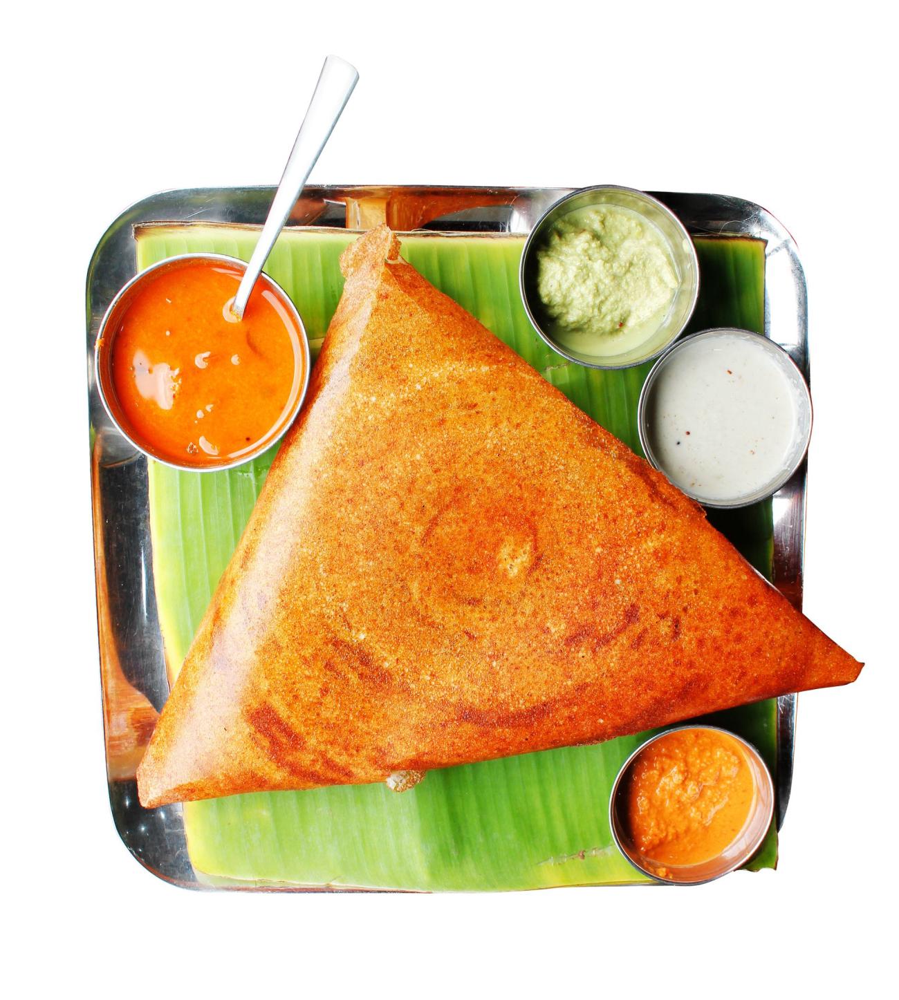 Popular south indian breakfast dosa in golden brown color with 3 types of chutney and sambar